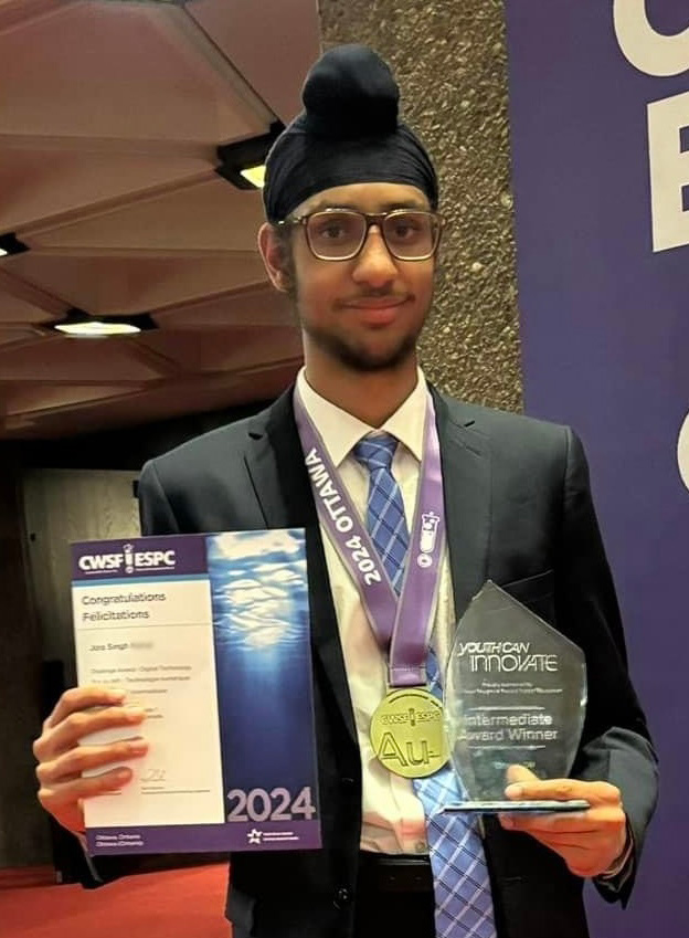 Jora Singh holding a certificate and an award at a science fair.