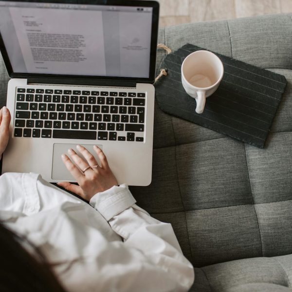 A woman looks at a word doc on her laptop.