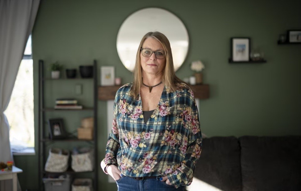 Kari standing in a living room.