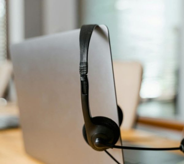 A headset resting on a laptop