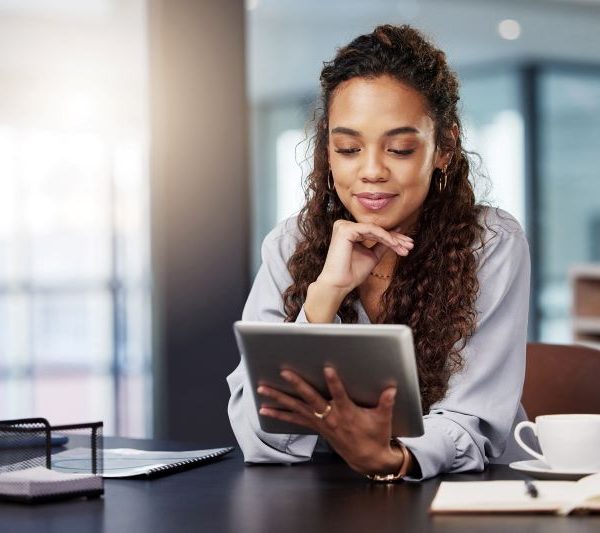 A woman looks at her tablet