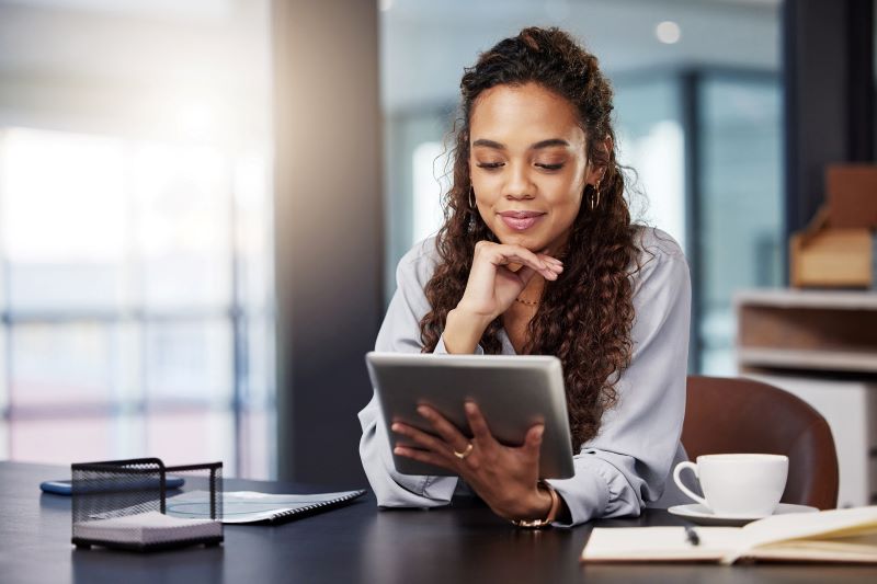 A woman looks at her tablet