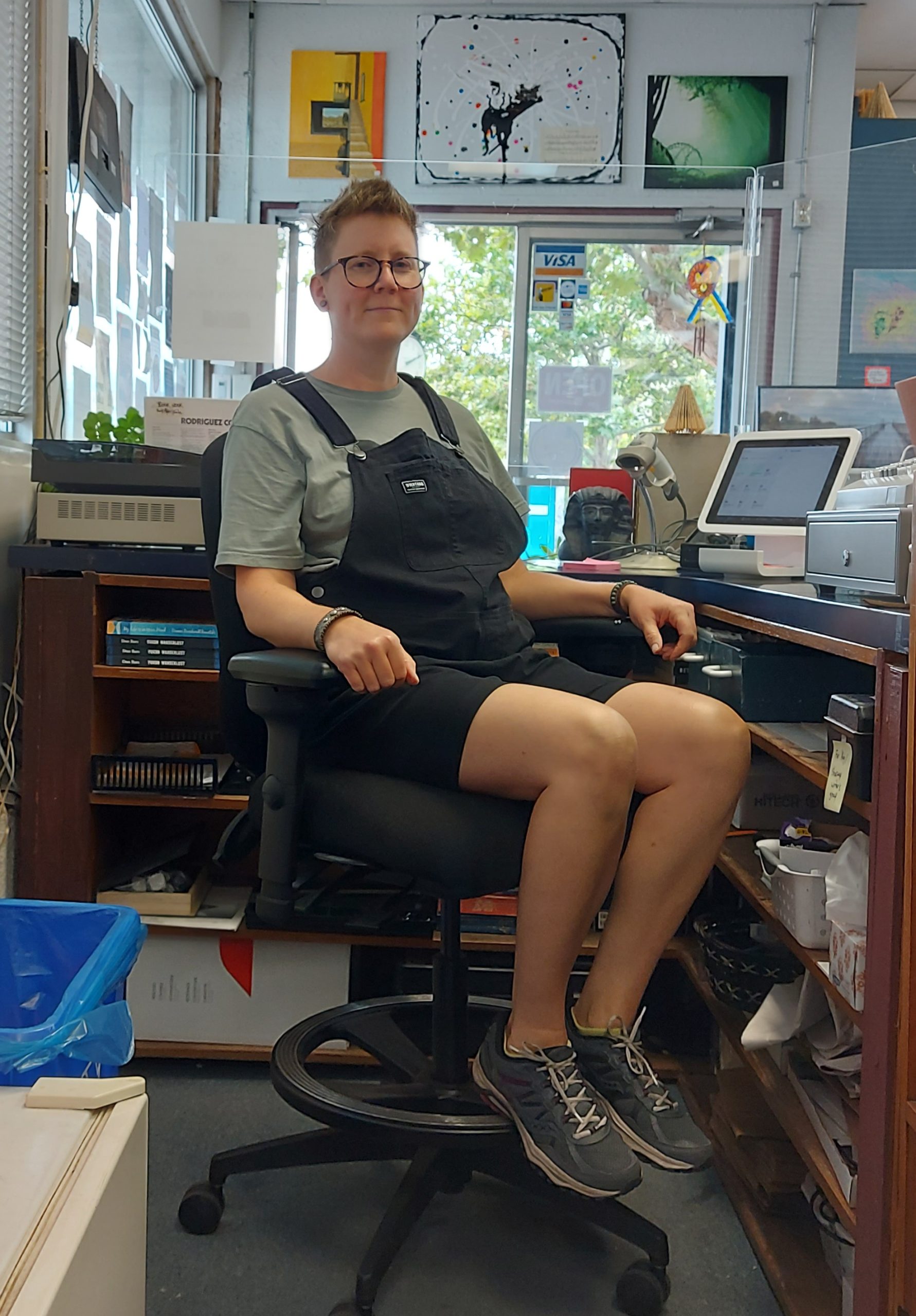 Leanne sitting at her desk in her ergonomic chair at work.