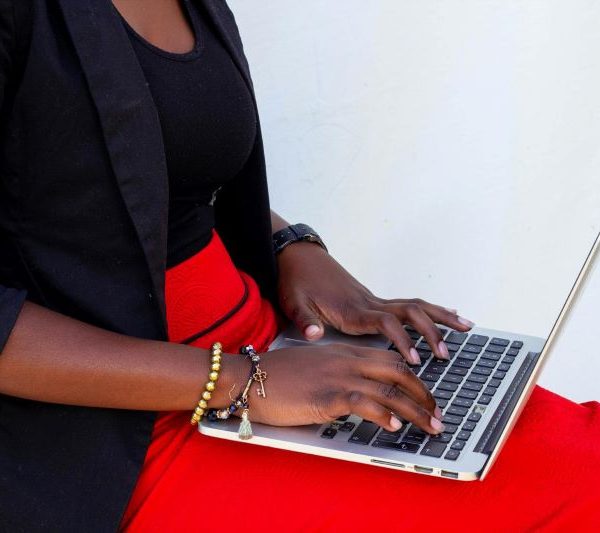 A woman types on a laptop.