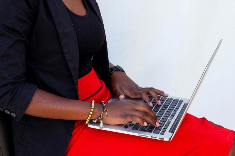 A woman types on a laptop.