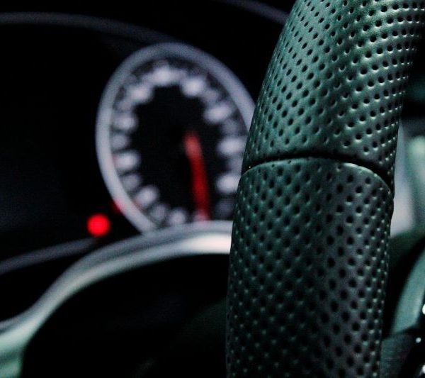 A close-up of a steering wheel in a car.