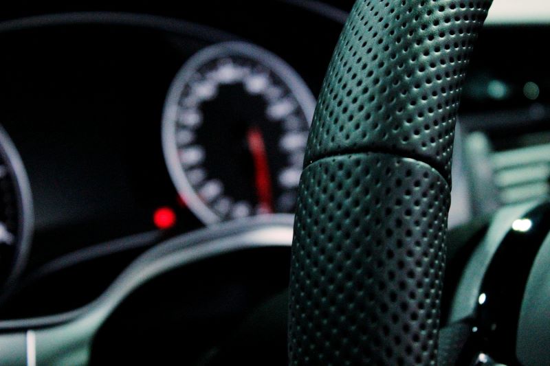 A close-up of a steering wheel in a car.