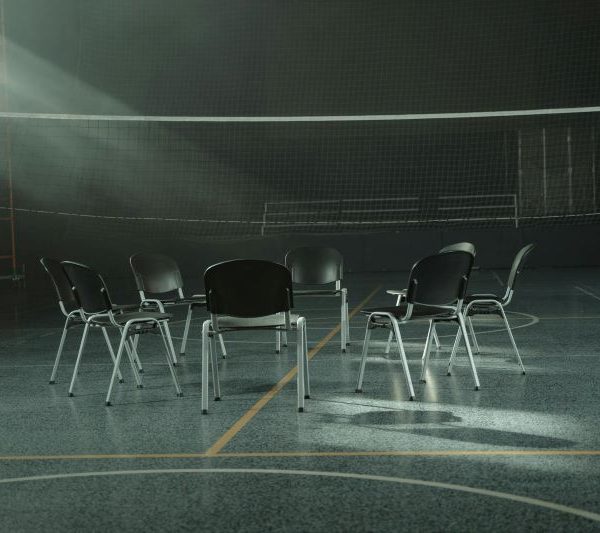 A circle of chairs in a gymnasium.