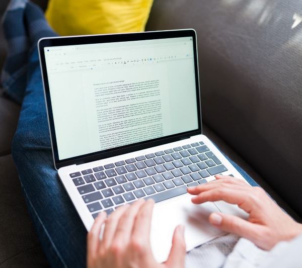 A person types on a laptop.