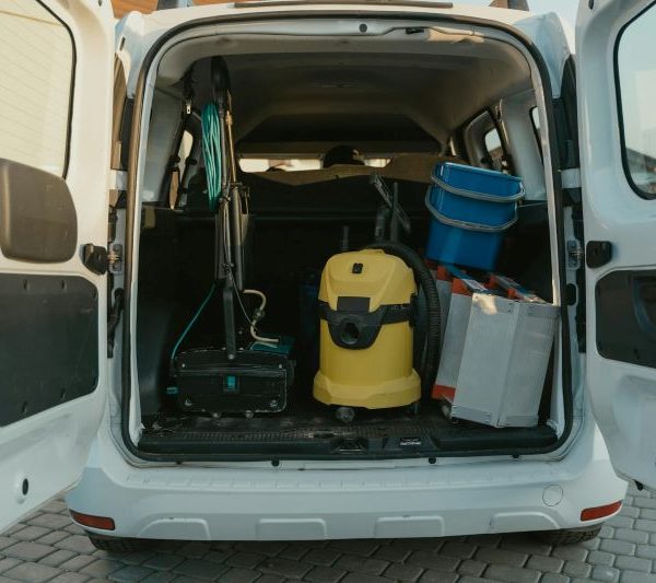 An open van with cleaning tools inside.